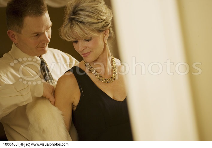 man-helping-woman-with-her-coat